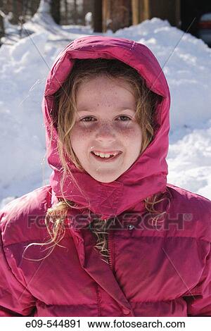 Girl, age 8 or 9, in puffy dark-pink parka with hood, hair escaping hood, looking at camera, one tooth missing, snow drift behind View Large Photo Image Stock Image - Girl, age 8 or 9, in puffy dark-pink parka with hood, hair escaping hood, looking at camera, one tooth missing, snow drift behind. Fotosearch