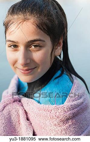 Girl aged 12 in a wetsuit and wrapped in a towel after a swim View Large Photo Image Stock Photography - Girl aged 12 in a wetsuit and wrapped in a towel after a swim. Fotosearch