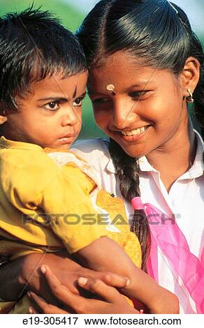 Girl and baby in Kerala, India View Large Photo Image Stock Photo - Girl and baby in Kerala, India. Fotosearch