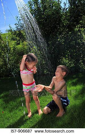 girl and boy having a shower outdoors, Switzerland View Large Photo Image Stock Photo - girl and boy having a shower outdoors, Switzerland. Fotosearch