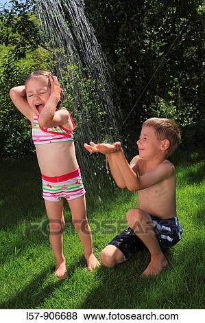 girl and boy having a shower outdoors, Switzerland View Large Photo Image Stock Photo - girl and boy having a shower outdoors, Switzerland. Fotosearch