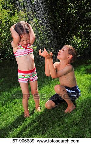girl and boy having a shower outdoors, Switzerland View Large Photo Image Stock Photo - girl and boy having a shower outdoors, Switzerland. Fotosearch