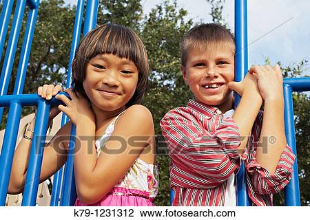 Girl and boy on school ground play equipment. View Large Photo Image Stock Image - Girl and boy on school ground play equipment.. Fotosearch