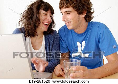 Girl and boy with laptop View Large Photo Image Stock Image - Girl and boy with laptop. Fotosearch