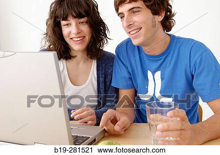 Stock Image - Girl and boy with laptop. Fotosearch