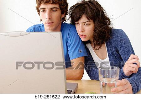 Stock Image - Girl and boy with laptop. Fotosearch