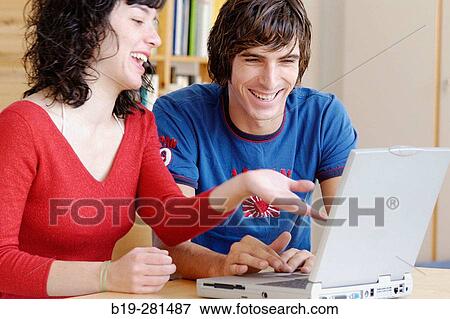 Girl and boy with laptop View Large Photo Image Stock Photo - Girl and boy with laptop. Fotosearch