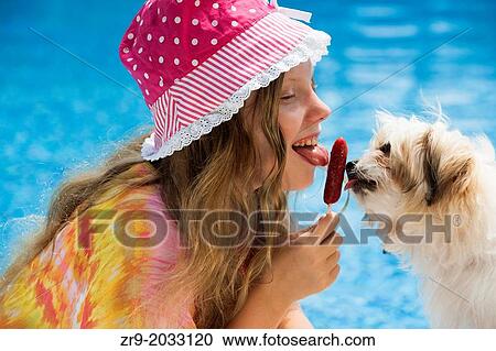 Girl and puppy sharing a popsicle. View Large Photo Image Stock Image - Girl and puppy sharing a popsicle.. Fotosearch