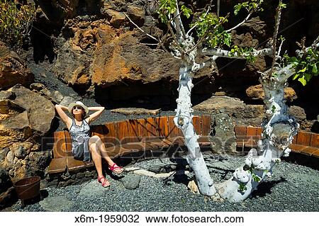 Girl and tree. Los Jameos del Agua. View Large Photo Image Stock Image - Girl and tree. Los Jameos del Agua.. Fotosearch