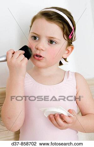 Girl applying make up with a brush View Large Photo Image Stock Image - Girl applying make up with a brush. Fotosearch