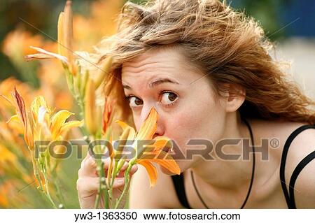 Girl at sunset outdoors near flowers View Large Photo Image Stock Image - Girl at sunset outdoors near flowers. Fotosearch