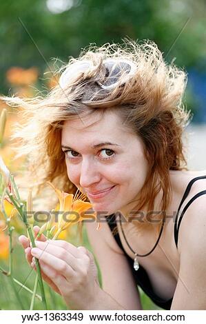 Girl at sunset outdoors near flowers View Large Photo Image Stock Photo - Girl at sunset outdoors near flowers. Fotosearch