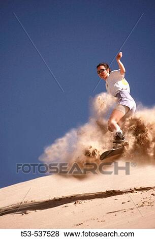 Girl blasts sand off ramp at Dumont Dunes. California. USA. View Large Photo Image Stock Photo - Girl blasts sand off ramp at Dumont Dunes. California. USA.. Fotosearch