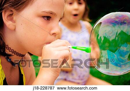 Girl blowing bubble View Large Photo Image Stock Photo - Girl blowing bubble. Fotosearch