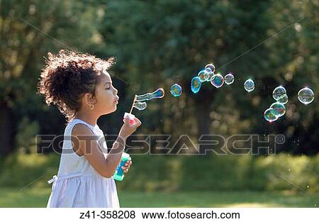 Stock Photo - Girl blowing bubbles. Fotosearch