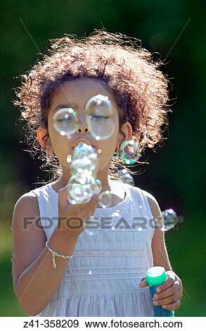 Girl blowing bubbles View Large Photo Image Stock Photo - Girl blowing bubbles. Fotosearch