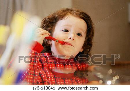 Stock Photography - Girl brushing teeth. Fotosearch