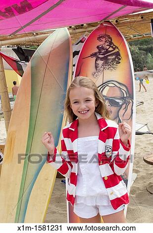 Girl by surf boards View Large Photo Image Stock Image - Girl by surf boards. Fotosearch