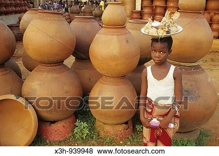 Stock Photo - Girl carrying a basket on her head, Benin. Fotosearch