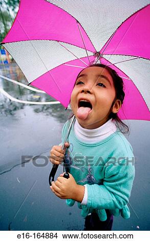 Girl catching raindrops View Large Photo Image Picture - Girl catching raindrops. Fotosearch