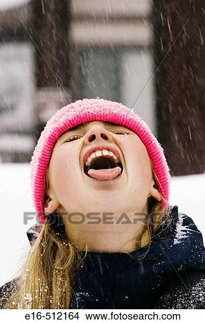 Girl catching snow in mouth View Large Photo Image Picture - Girl catching snow in mouth. Fotosearch
