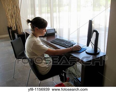 Girl chatting on a computer View Large Photo Image Stock Photo - Girl chatting on a computer. Fotosearch