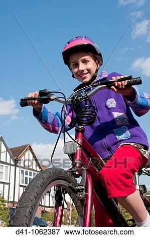girl child cycling on road 10 year old View Large Photo Image Stock Photo - girl child cycling on road 10 year old. Fotosearch