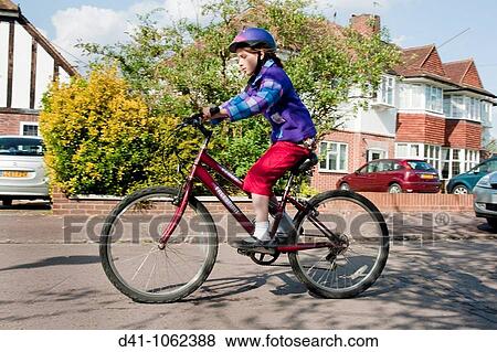 girl child cycling on road 10 year old View Large Photo Image Stock Photo - girl child cycling on road 10 year old. Fotosearch