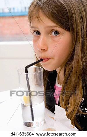 Girl child drinking water with straw View Large Photo Image Picture - Girl child drinking water with straw. Fotosearch