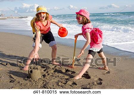 girl children on beach 2 sisters bucket & spade View Large Photo Image Stock Photography - girl children on beach 2 sisters bucket & spade. Fotosearch
