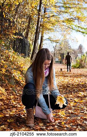 Girl collecting fallen leaves. Wolfgang lake, Austria. View Large Photo Image Stock Photography - Girl collecting fallen leaves. Wolfgang lake, Austria.. Fotosearch