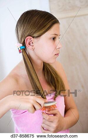 Girl combing herself in the bathroom View Large Photo Image Stock Photography - Girl combing herself in the bathroom. Fotosearch