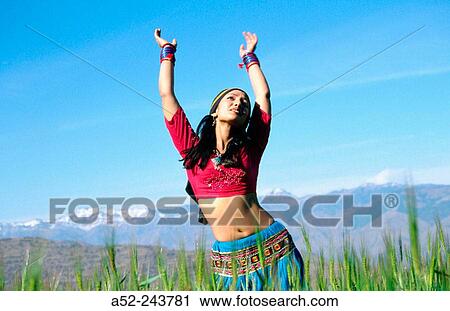 Stock Image - Girl dancing in the Himalayas. Uttaranchal. India. Fotosearch