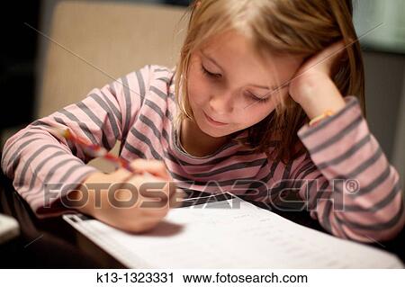 Stock Image - Girl doing schoolwork. Fotosearch