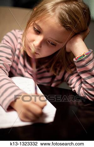 Stock Image - Girl doing schoolwork. Fotosearch