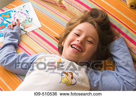 Girl drawing in her room View Large Photo Image Stock Photograph - Girl drawing in her room. Fotosearch