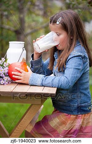 Girl drinking a glass of milk outdoor in the garden. Slovenian countryside. View Large Photo Image Stock Image - Girl drinking a glass of milk outdoor in the garden. Slovenian countryside.. Fotosearch