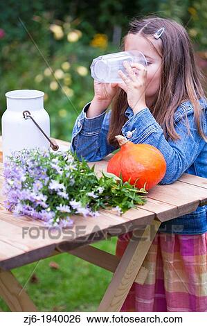 Girl drinking a glass of milk outdoor in the garden. Slovenian countryside. View Large Photo Image Stock Photograph - Girl drinking a glass of milk outdoor in the garden. Slovenian countryside.. Fotosearch