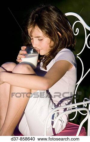 Girl drinking a glass of milk View Large Photo Image Stock Image - Girl drinking a glass of milk. Fotosearch