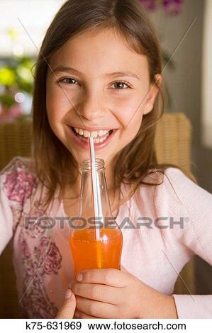Girl drinking a soft drink View Large Photo Image Stock Photo - Girl drinking a soft drink. Fotosearch