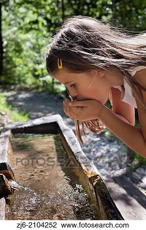 Girl drinking fresh water. Slovenian Alps. View Large Photo Image Stock Image - Girl drinking fresh water. Slovenian Alps.. Fotosearch