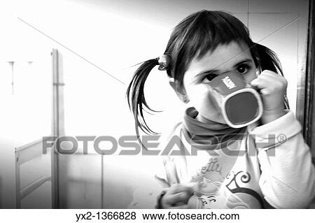 Girl drinking from a cup View Large Photo Image Stock Photo - Girl drinking from a cup. Fotosearch