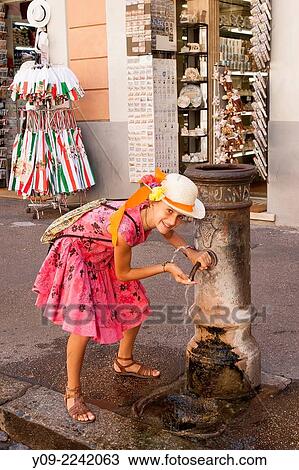 Girl drinking from a fountain or nasoni, Rome, Lazio, Italy. View Large Photo Image Stock Image - Girl drinking from a fountain or nasoni, Rome, Lazio, Italy.. Fotosearch