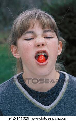 Girl eating a candy View Large Photo Image Stock Photo - Girl eating a candy. Fotosearch