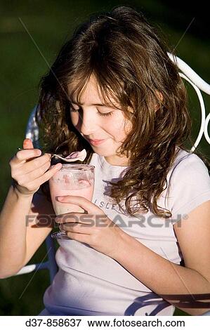Girl eating a fruit ice cream View Large Photo Image Stock Photo - Girl eating a fruit ice cream. Fotosearch