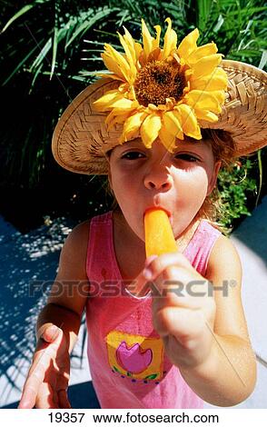 Girl eating a popsicle View Large Photo Image Stock Photo - Girl eating a popsicle. Fotosearch