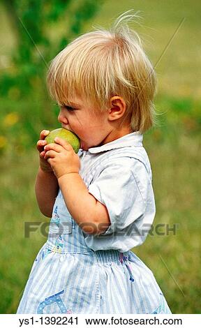 Stock Image - Girl Eating Apple. Fotosearch