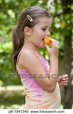Girl eating apricot. View Large Photo Image Stock Image - Girl eating apricot.. Fotosearch
