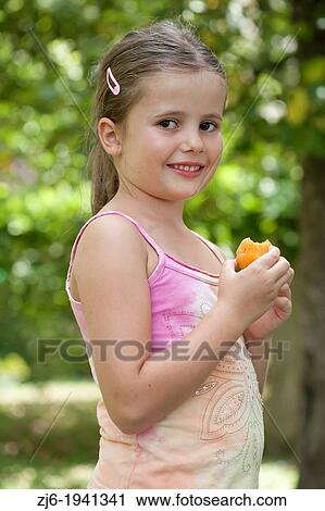 Girl eating apricot. View Large Photo Image Stock Image - Girl eating apricot.. Fotosearch