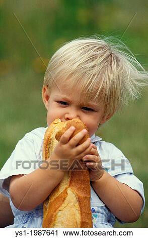 Stock Image - Girl eating French Bread Stick.. Fotosearch